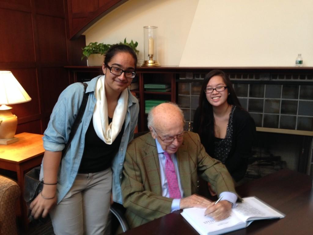 The author and fellow HHMI participant Nhi Le visit with Nobel Laureate James D. Watson.