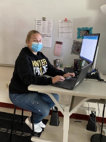 Science teacher Ms. Ryan working at her desk.